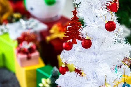 Close up of Colorful balls on Green Christmas tree with gifts background Decoration During Christmas and New Year.の写真素材
