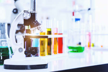 Microscope and test tubes with lab glassware in laboratory background, research and Scientific conceptの写真素材