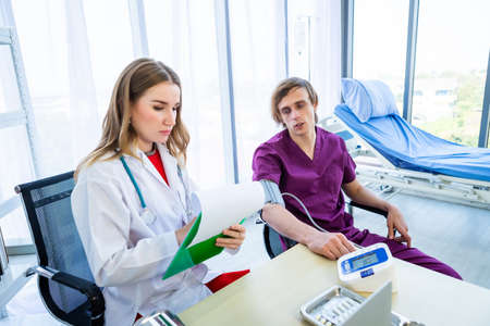 female doctor therapeutic advising with positive emotions to a man patient on Bed with Digital...