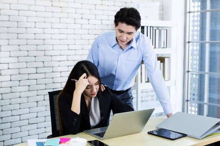Two businesswoman are stressed at work With business man partners helping to make positive...