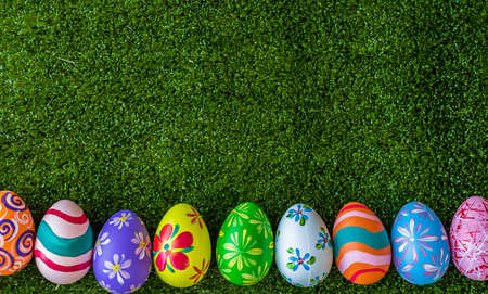 Easter holiday concept,Colorful Easter eggs line up green grass background with space.の写真素材