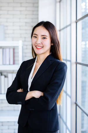 Portrait of a cheerful mature Asian businesswoman at In the office room background,business...