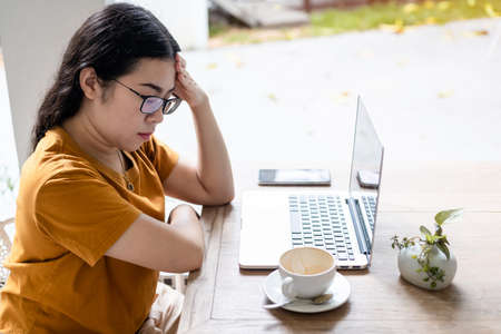 Stressed of freelance people business female wearing protective mask casual having a headache after...