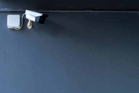 CCTV Security camera equipment are installed along on wall dark modern building Safety system area...