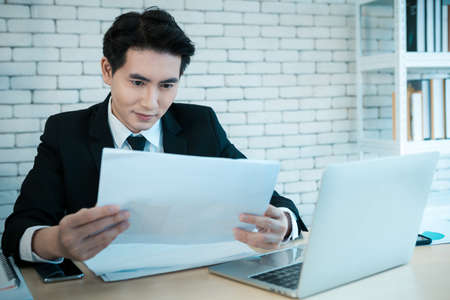 Happy of successful asian young businessman have stressed see a the document business plan and...