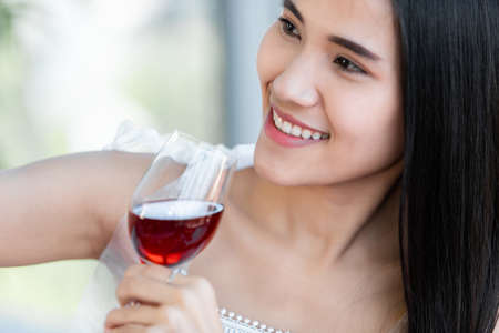 Selfie using a smartphone of Happy of smiling Asian young female sitting at a table food holding...