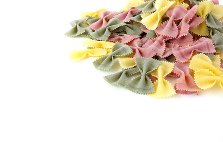 Heap of extra large multicolored farfalle pasta isolated on a white background.の写真素材