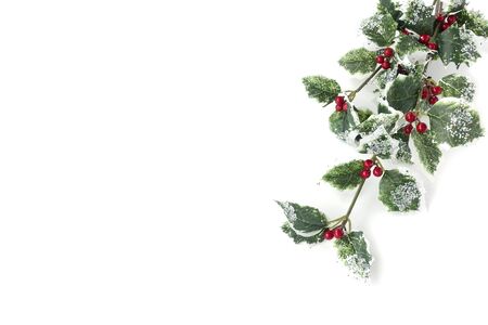 Artificial holly branch -  ilex aquifolium, with fruits, glass stones and glitter isolated on white background with copy space.の写真素材