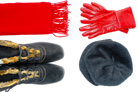 Flat Lay of women black winter boots, a red cashmere scarf, a black angora cap and red leather gloves isolated on white background.の写真素材