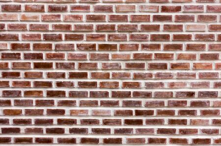 Moroccan red brick stone wall as background.
