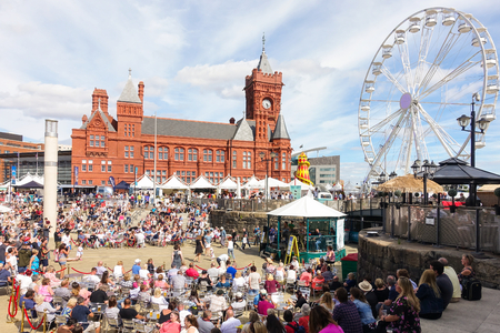 Cardiff, United Kingdom -  July 14, 2017: People are enjoying themselves and listen to music on the opening day of the Cardiff International Food Festival 2017 at Roald Dahl Plass, Cardiff Bay, Cardiff, Wales, UK.のeditorial素材