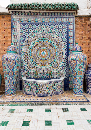 Fez, Morocco - May 07, 2017: Typical handmade moroccan mosaic fountain and vases in the courtyard of the Mosaic Factory in Fez, Morocco, Africa.のeditorial素材