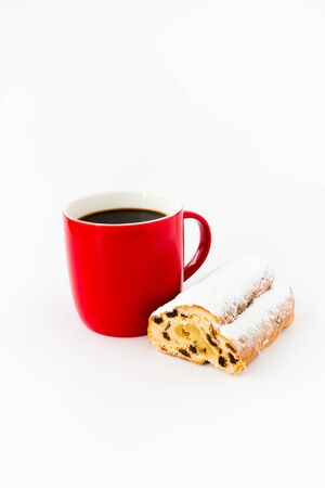 Mini Stollen and red mug filled with black coffee isolated on white.の写真素材