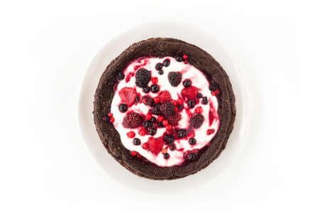 Chocolate cloud cake, flourless, with creme fraiche and frozen summer berries isolated on white background. Top view.の写真素材