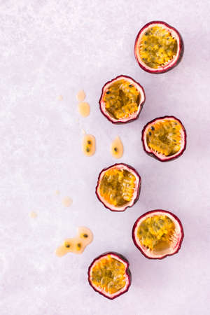 Flat lay of fresh passion fruit on pastel purple background with copy space. Top view.の写真素材