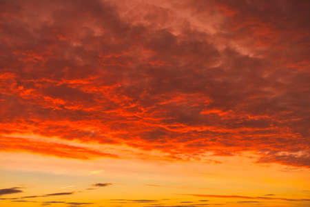 Dramatic, fiery, cloudscape at sunrise. Sky replacement.の写真素材