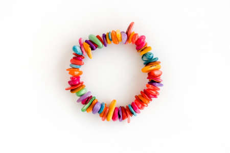 Top view of a colorful freshwater shell chip bracelet isolated on white. Handmade jewelry for Children, teenager and women.の写真素材