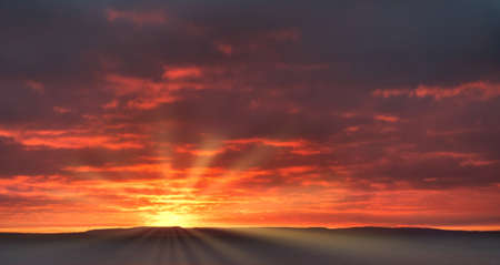Sunrise Sky with sun, sunrays and dramatic dark, moody clouds. Panorama. Sky replacement. Cloudscape.の写真素材