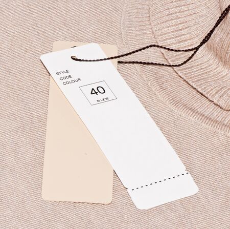 The label is attached to a sweater 