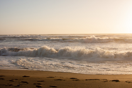beach water waves at sunsetの写真素材