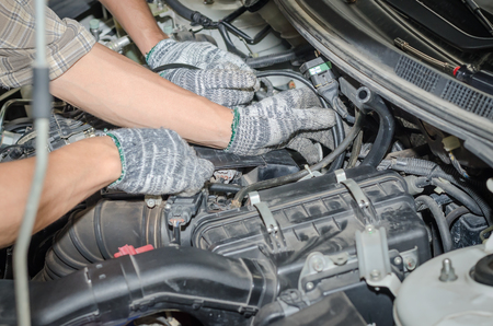 Auto mechanics repairing a car LPG system.の写真素材