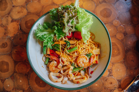 Spaghetti spicy seafood is placed on the table.の写真素材