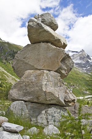 versized stone hand on snow lakeの写真素材
