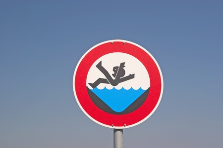 Warning sign on the bank of a canalの写真素材