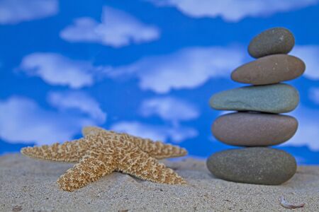 Stone tower with a starfish on the beachの写真素材