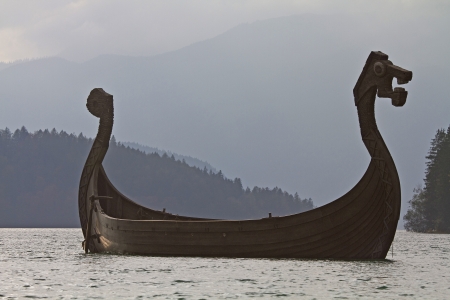 Viking ship in Walchensee against the lightの写真素材