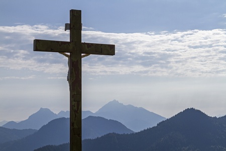 Summit cross of Kreuberges in the Tegernsee Alps in backlightの写真素材
