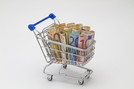 Miniature shopping cart with many euro notesの写真素材