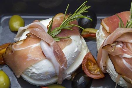 Filled mozzarella wrapped in bacon slices and bake in the ovenの写真素材