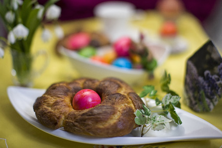 Easter baking - yeast pastries decorated with colored easter egg