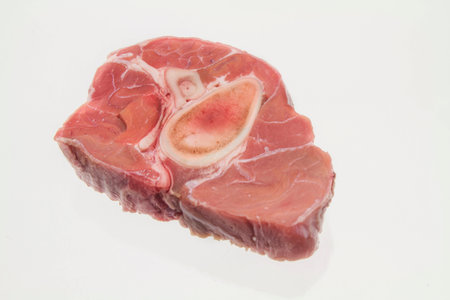 Raw slice of veal shank on a white backgroundの写真素材