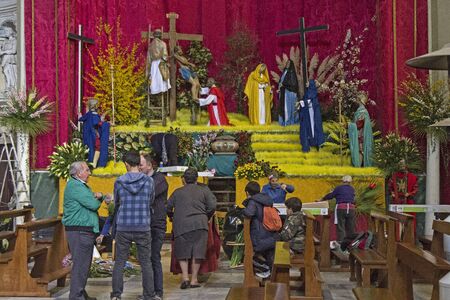 Easter preparations establishment of a religious scene in Ligurian village church