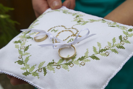 Still life at the wedding ceremony - two wedding rings on a ring pillowの写真素材