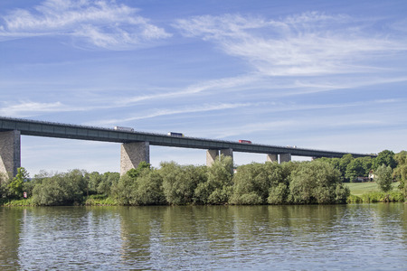 Lorry trucks cross the busy highway bridge near Regensburg across the Danubeの写真素材