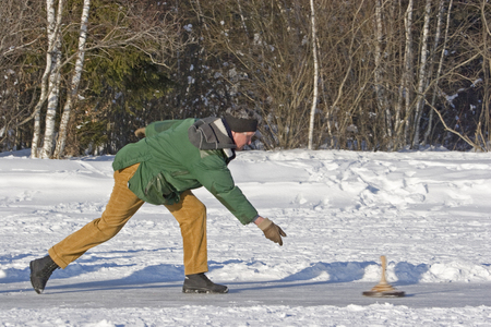 Curling on a frozen lake -  popular sport in winter time