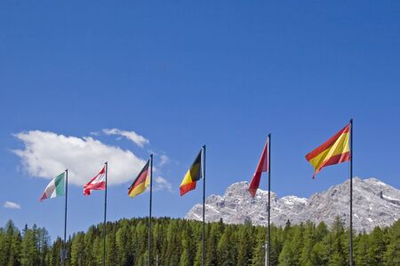 The flags of various European countries flutter on the pass