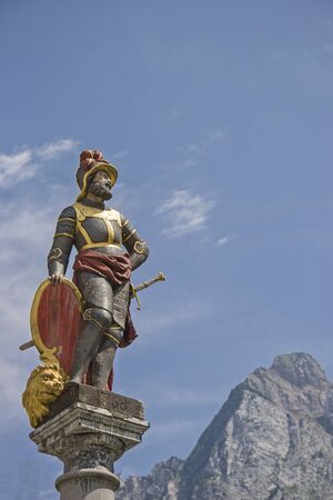 The Fountain MÃ¤ndl on the main square of the swiss canton capital before the summit of Mythenの写真素材