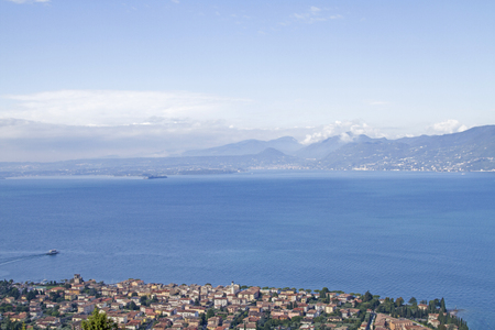 View from "Balcone del Garda" behind the church in Albisano on the Garda lake and the medieval town of Torri del Benacoの写真素材