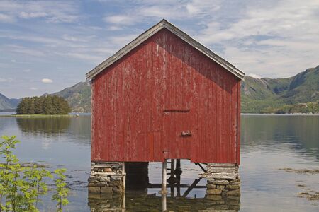 Red boat huts in Sor Eitran idyllically built on piles in the Eiterfjorden