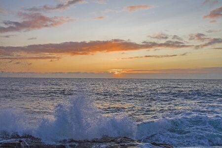 The sun makes a short statement after a bad weather day on the Atlantic coastの写真素材