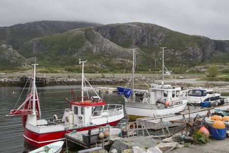Lonely fishing port with fishing trawler in a bay of the idyllic Lekafjordenの写真素材