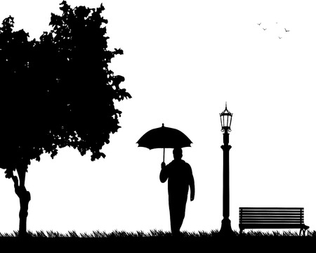 Young man walking under the umbrella in park in autumn or fall, one in the series of similar images silhouetteのイラスト素材