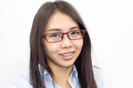 A thai woman wearing blue shirt smiling