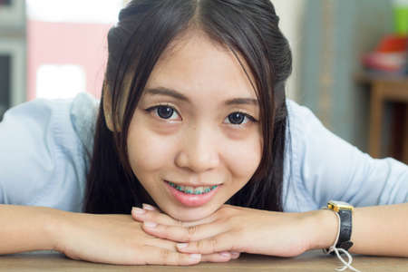 A thai woman wearing blue shirt smilingの写真素材