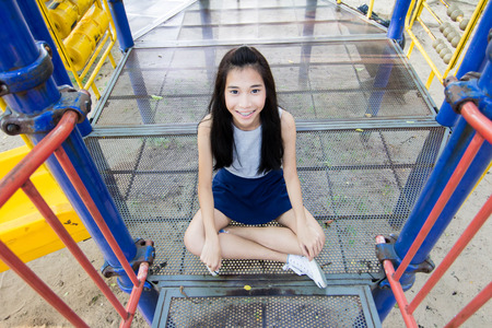 Portrait of thai student teen beautiful girl happy on toy and relax On Parkの写真素材