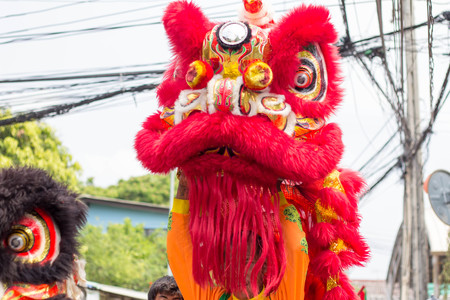 BANGKOK, THAILAND - April 4 2015: Unidentified people of parade Local tradition Thailand, Thai people playing chinese lion dance to celebrate of Songkran Thai new year  water festivalのeditorial素材